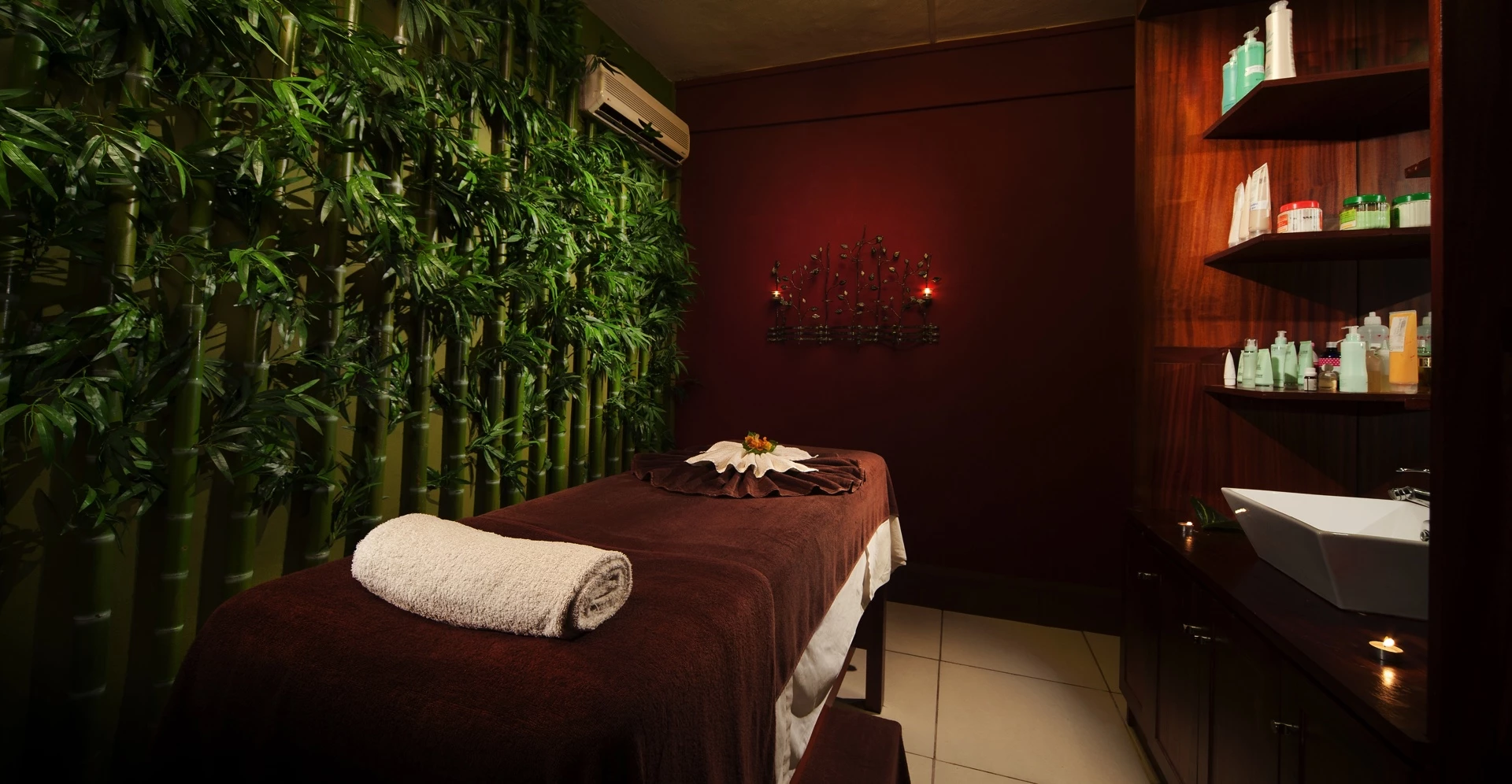 Spa treatment room at Le Palmiste Resort & Spa with massage table and relaxing tropical ambiance.