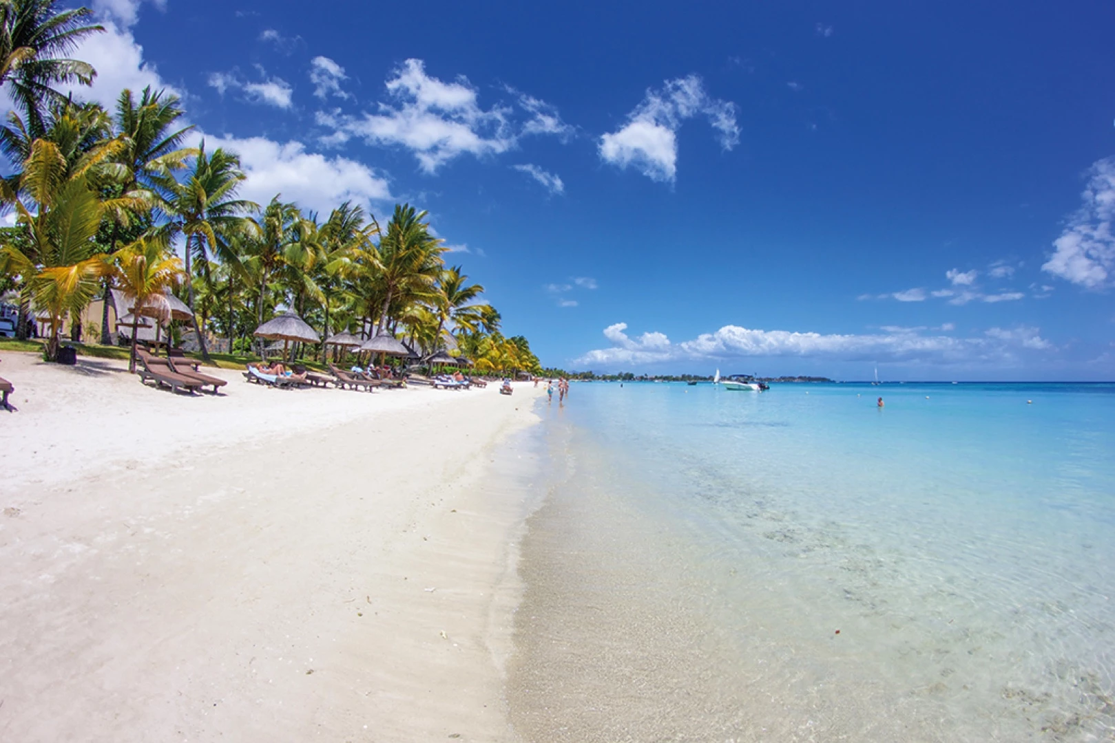 Trou aux Biches beach in Mauritius, with white sand and turquoise lagoon, located a short walk from Le Palmiste Resort & Spa.
