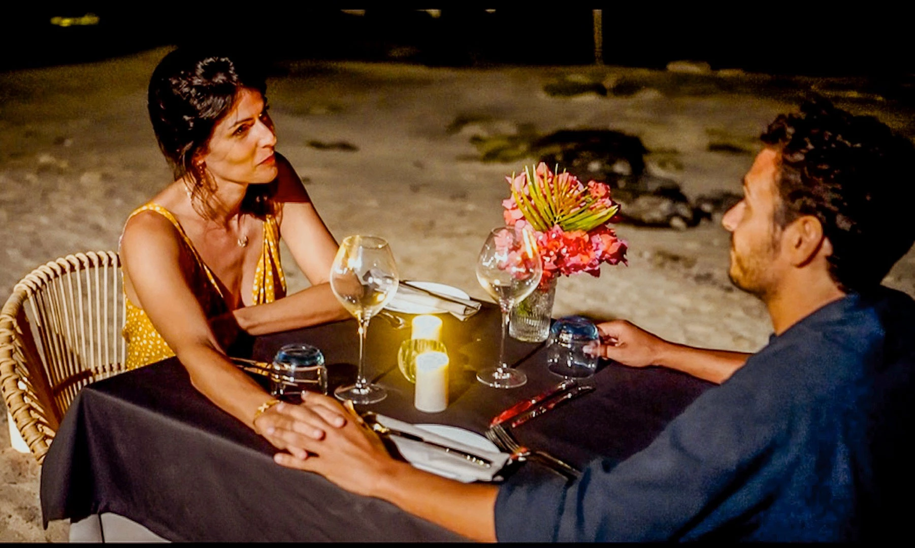 Romantic beachfront dinner at Wonders Beach with a table set for two by the water