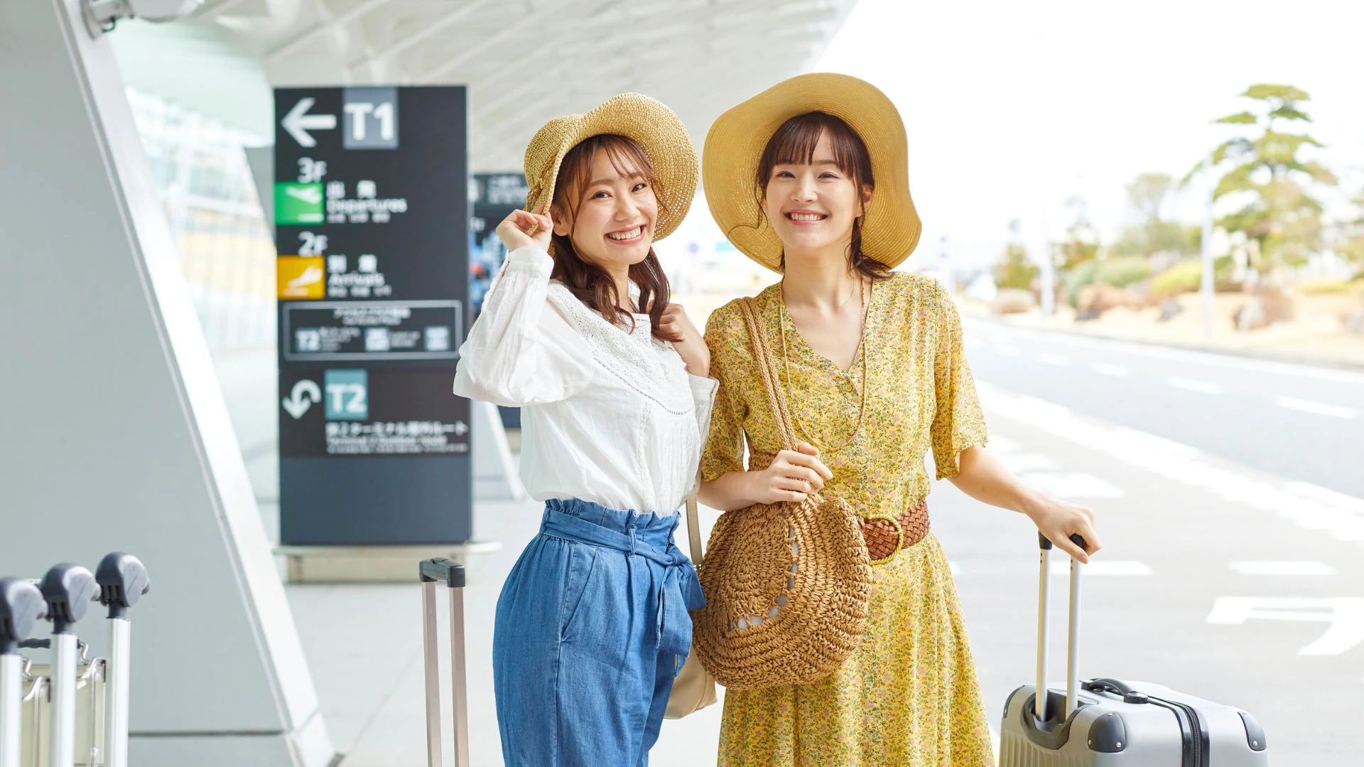 Happy travelers picking up an Alain Car Rental vehicle at the airport.